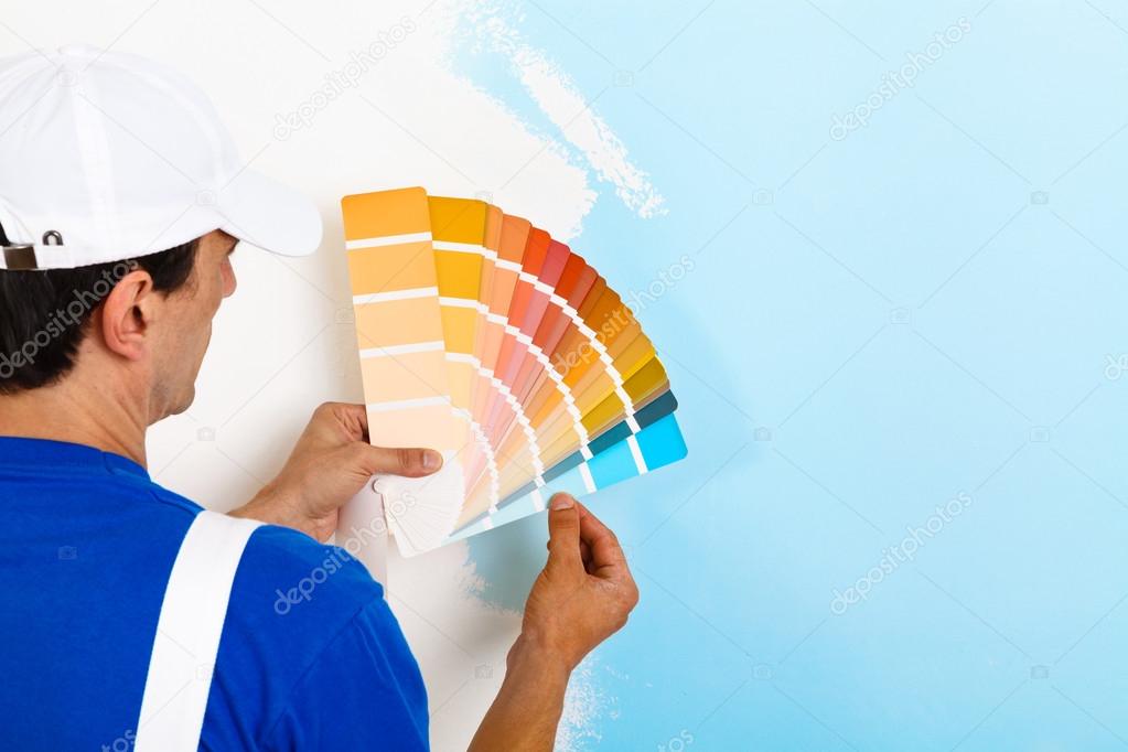painter man looking a color palette 