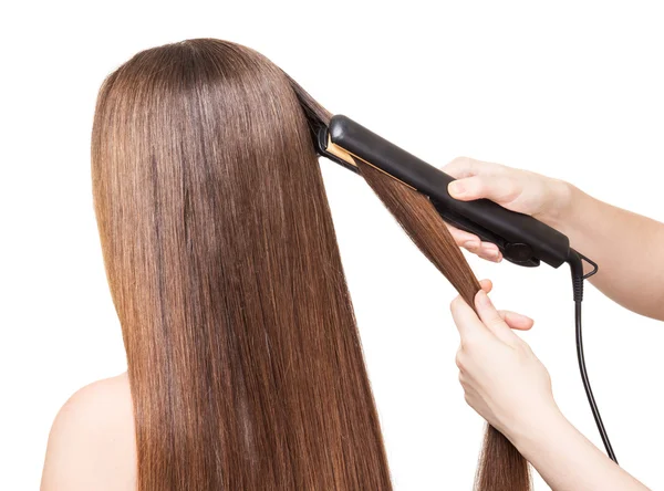 Makeup artist aligns long hair Curling on white — Stock Photo, Image