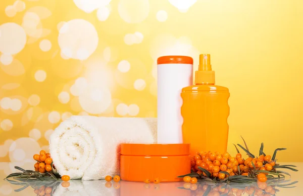 Towels and toiletries in the bathroom on an abstract yellow — Stock Photo, Image