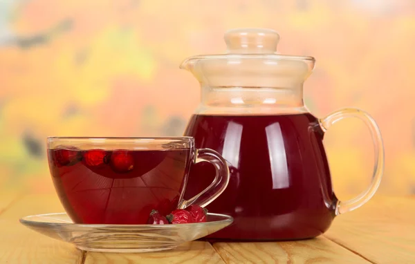 Tea from rose hips in cup and teapot on table — Stock Photo, Image