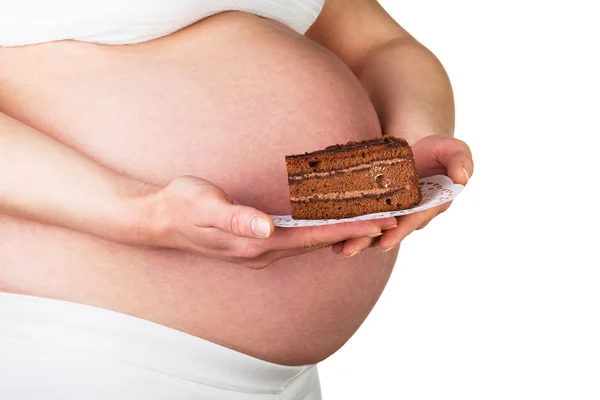Těhotná žena drží kus dortu izolované na bílém — Stock fotografie