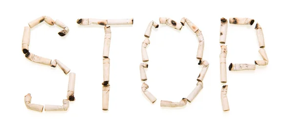 STOP sign Laid isolated from cigarette butts on a white — Stock Photo, Image