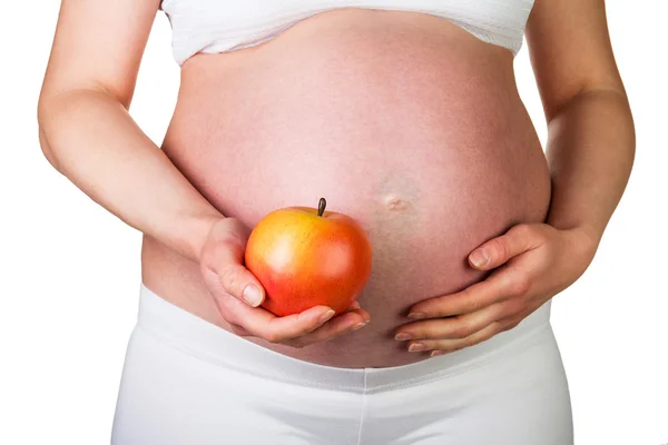 Mujer embarazada con manzana en mano aislada en blanco — Foto de Stock