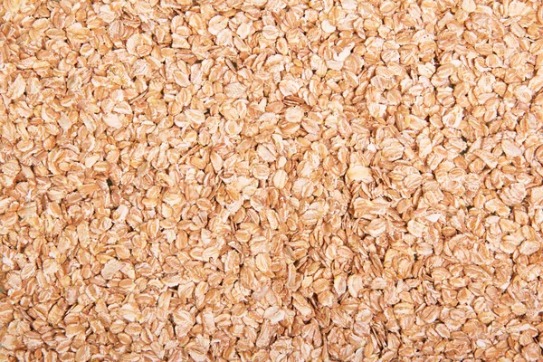 Uncooked oatmeal close-up for the preparation dietary dishes. Texture. — Stock Photo, Image
