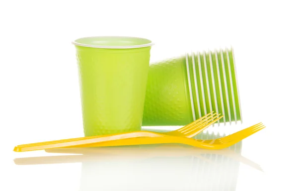 Зелені пластикові чашки і жовта виделка ізольовані на білому — стокове фото