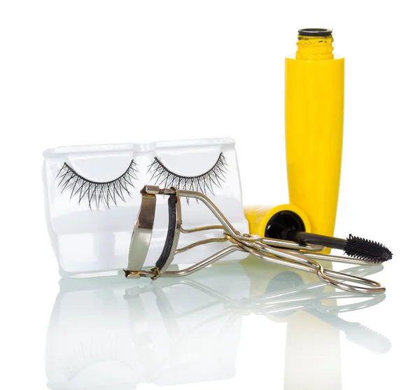 Black false eyelashes, mascara and hair curlers isolated on white. — Stock Photo, Image