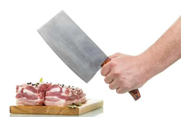 Raw pork meat, cutting board, mans hand holding knife. — Stock Photo, Image