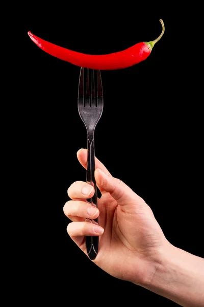 Mano con tenedor y empalado su chile rojo aislado  . — Foto de Stock