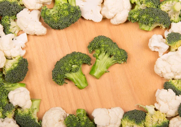 Fresh broccoli and cauliflower on  background  light wood. — Stock Photo, Image