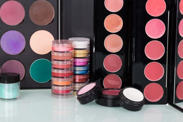 Professional cosmetics: eyeshadow, lip gloss, blush and powder make-up.