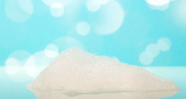 The soap foam in  bathtub on  abstract blue background. — Stock Photo, Image