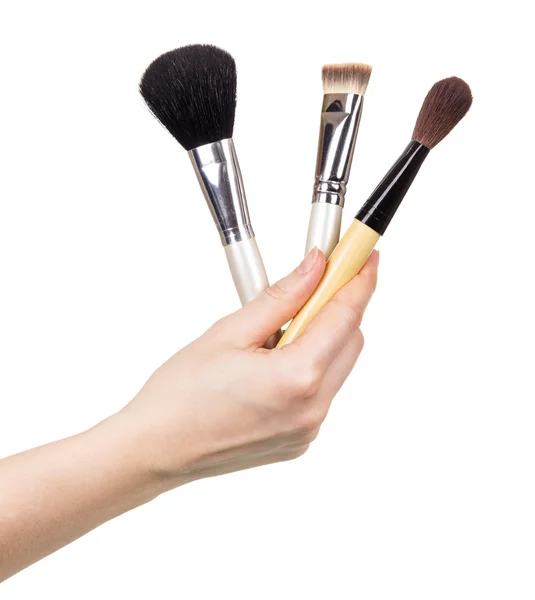 Cosmetic brush in  female hand isolated on white background. — Stock Photo, Image