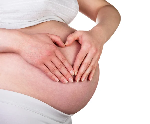 Pregnant woman fingers folded on his stomach in form  heart. — Stock Photo, Image