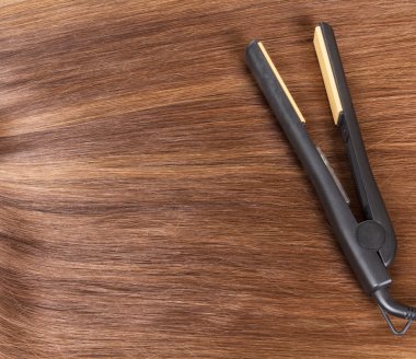 Kumral arka plan üzerinde düz Saç Düzleştirici.