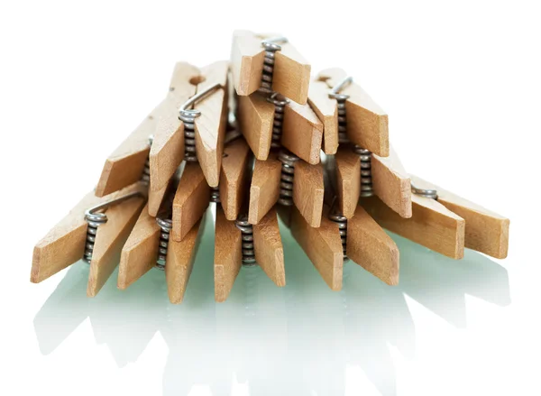 Pile of wooden clothespins isolated on white. — Stock Photo, Image