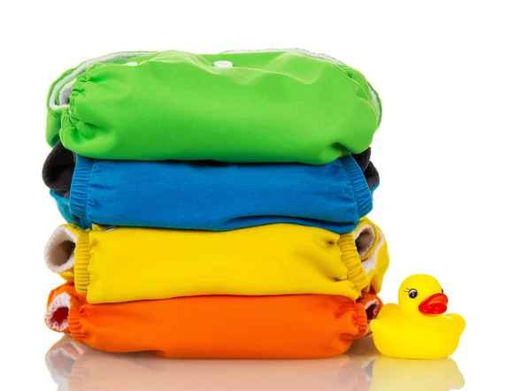 Organic cloth diapers and rubber duck isolated on white. — Stock Photo, Image