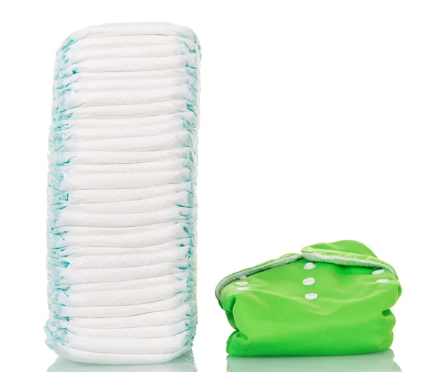 Stack of disposable and one reusable diaper  isolated on white. — Stock Photo, Image