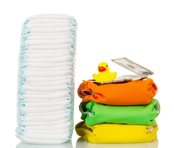 Stacks  disposable and cloth diapers, money, rubber duck isolated. — Stock Photo, Image