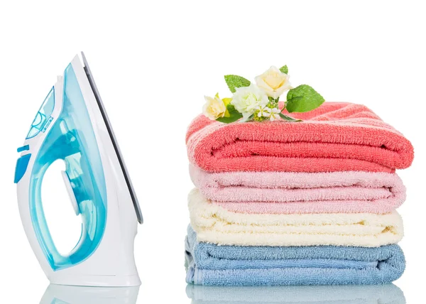 Steam iron and colorful towels isolated on white — Stock Photo, Image