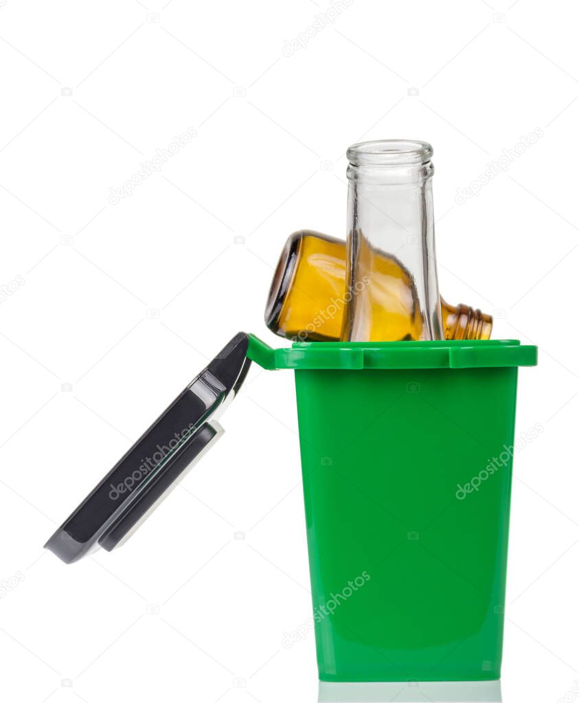 Household waste sorting concept. Green trash bin for glass rubbish bottles isolated on white background