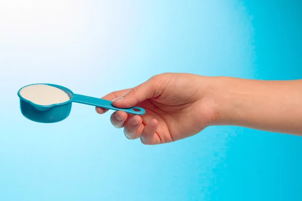 Container with Washing powder in hand — Stock Photo, Image