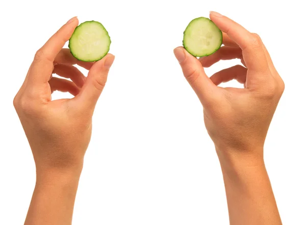 Hands with cucumber slices — Stock Photo, Image