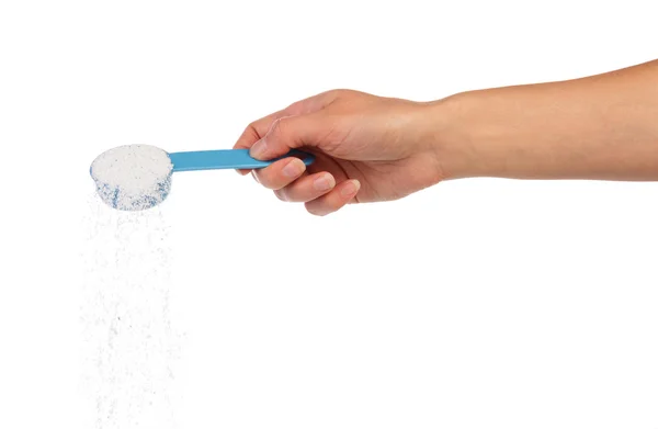 Washing powder in measuring cup in hand — Stock Photo, Image