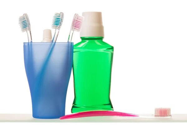 Toothpaste and toothbrushes on shelf — Stock Photo, Image