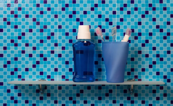 Toothbrushes on bathroom shelf — Stock Photo, Image