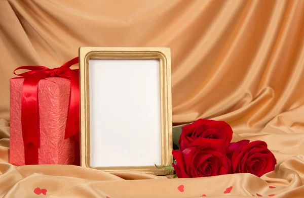 Roses and a frame on a cloth — Stock Photo, Image