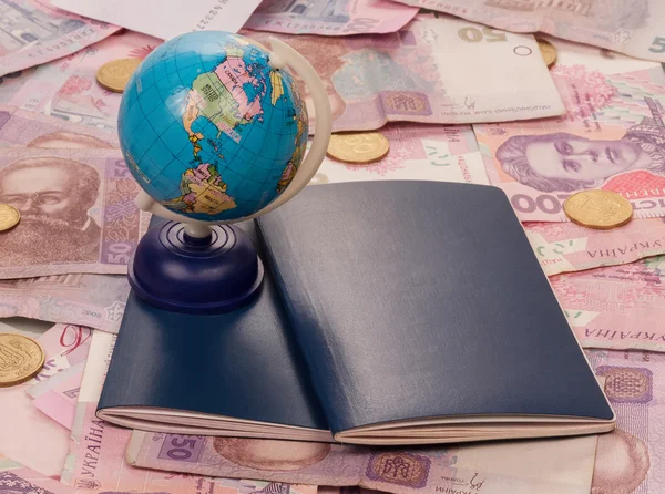 Passport and globe on money