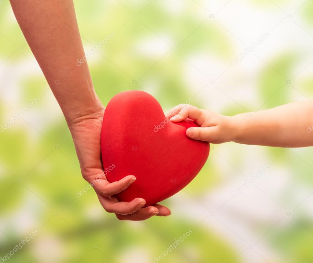 Man and child hands holding heart
