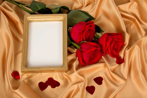 Roses in a and a frame on a cloth Stock Photo