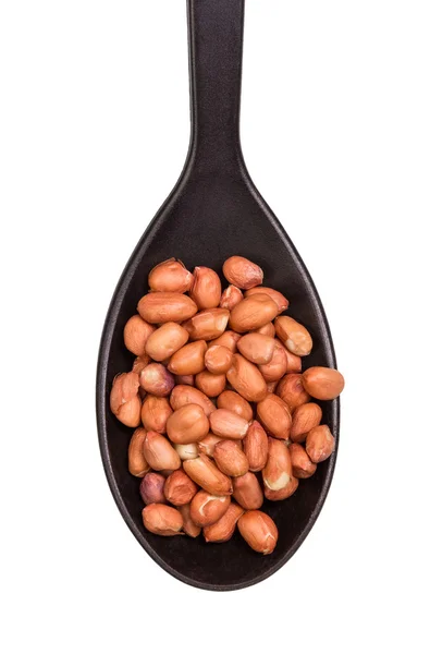 Nueces en cuchara negra — Foto de Stock