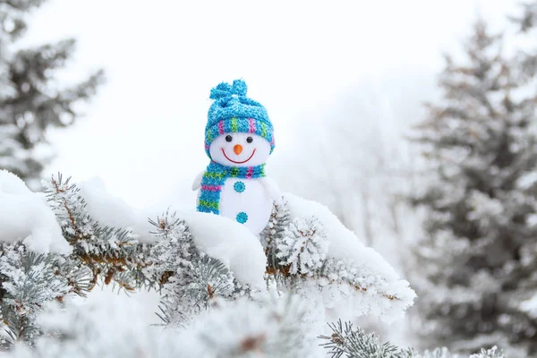 Snowman on fir branch in the forest — Stock Photo, Image