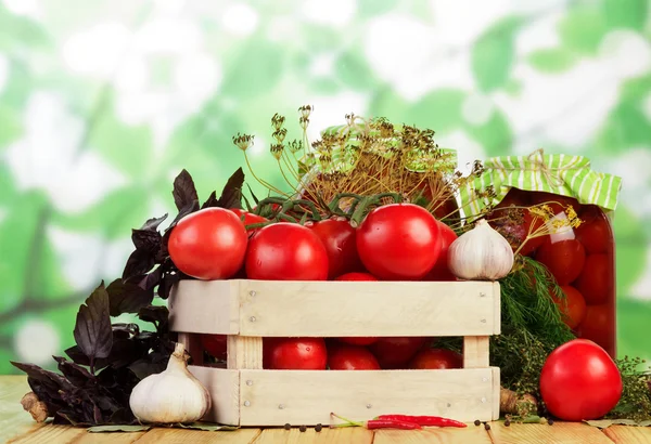 Tomatoes with garlic on table — Stock Photo, Image