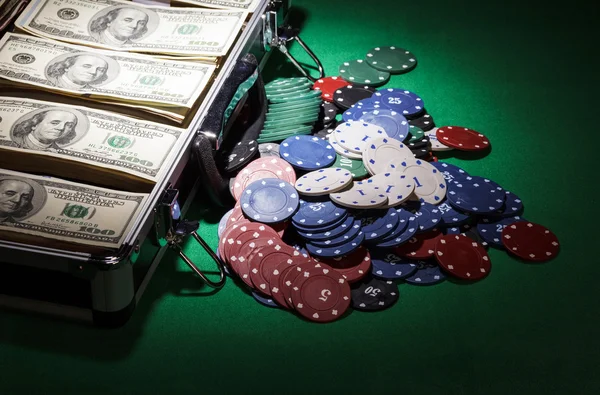 Suitcase with dollars and near casino chips — Stock Photo, Image