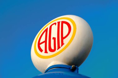 ROME, ITALY - Aug 04, 2020: The Agip logo on the top of an old gas station. Agip was an italian petrol company established in 1926. Since 2003 it is part of ENI oil company. clipart