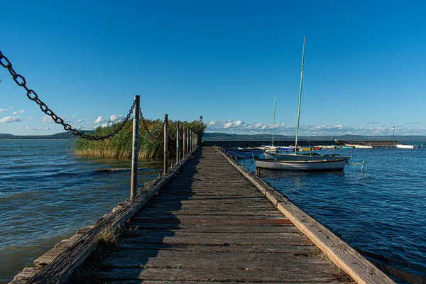 A wooden pontoon with boats on Lake Balaton, Hungary