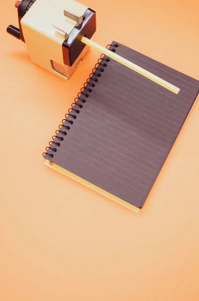 Vertical Shot Notebook Mechanical Pencil Sharpener Orange Surface — Stock Photo, Image