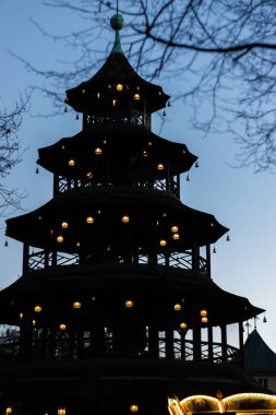 Silhouette of illuminated Chinese Tower in English Garden, Munich. clipart
