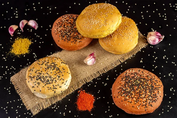 Tasty freshly baked hamburger buns with grains on a black background — Stock Image Tasty Freshly Baked Hamburger Buns Grains Black Background Royalty Free Stock Images
