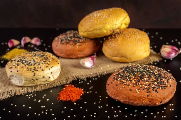 Tasty freshly baked hamburger buns with grains on a black background — Stock Image Tasty Freshly Baked Hamburger Buns Grains Black Background Royalty Free Stock Photos
