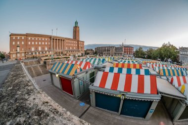 NORWICH, UNITED KINGDOM - Aug 31, 2020: A wide angle fisheye view looking over the colourful outdoor market stalls in the city of Norwich. T clipart