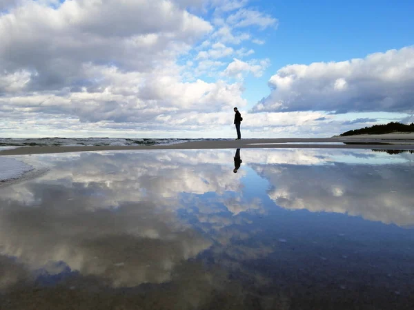 A mesmerizing shot of a seascape with a man reflection in Poland