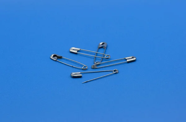 Closeup Safety Pins Isolated Blue Background — Stock Photo, Image