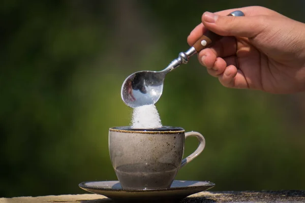 Closeup Teaspoon Sugar Being Poured Cup Hot Black Coffee Isolated — Stock Photo, Image