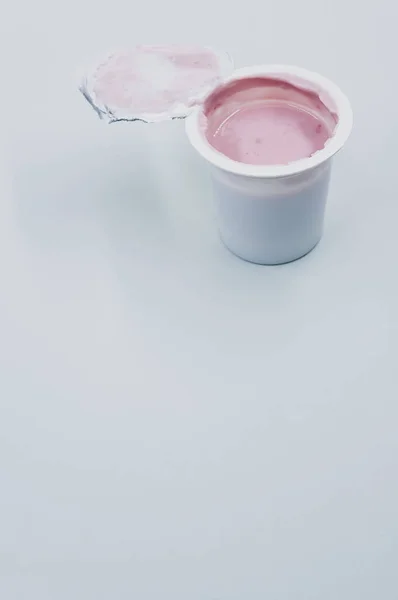 Вертикальний Знімок Відкритої Пластикової Ємності Фруктового Йогурту Білій Поверхні — стокове фото