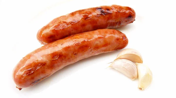 Closeup Roasted Delicious Sausages Garlic White Surface — Stock Photo, Image