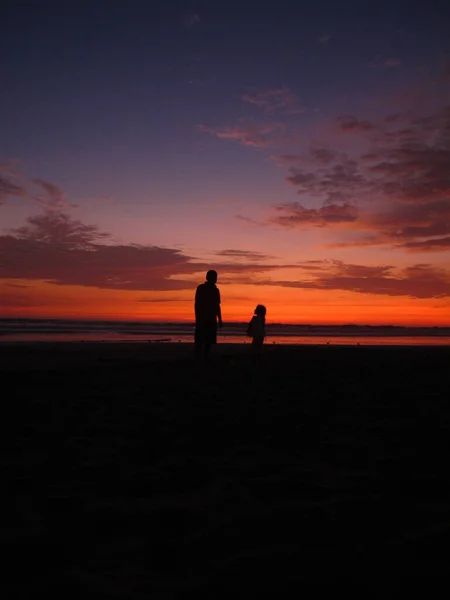 Μια Σιλουέτα Τον Πατέρα Περπατάει Στην Παραλία Παιδί Του Κάτω — Φωτογραφία Αρχείου